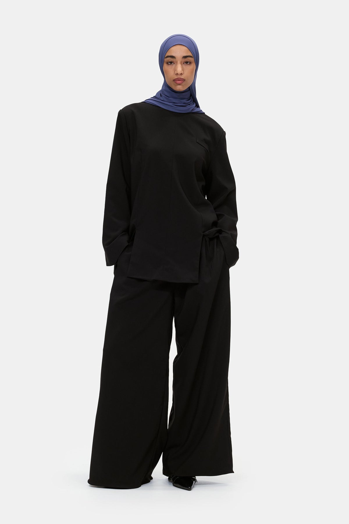 The Structured Trousers in Black, worn with the Structured Top
