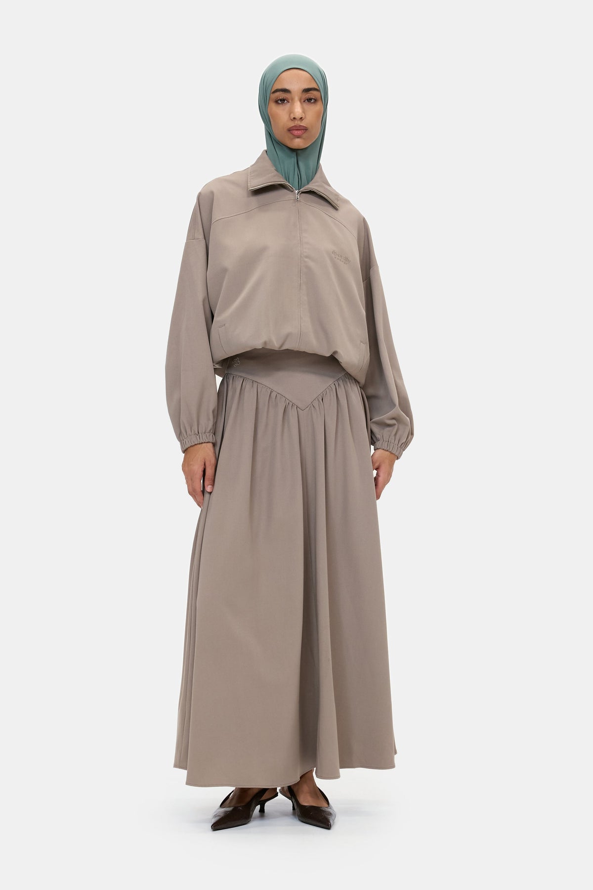 The Sculpted Jacket in Warm Taupe, front, worn with the Sculpted Maxi Skirt