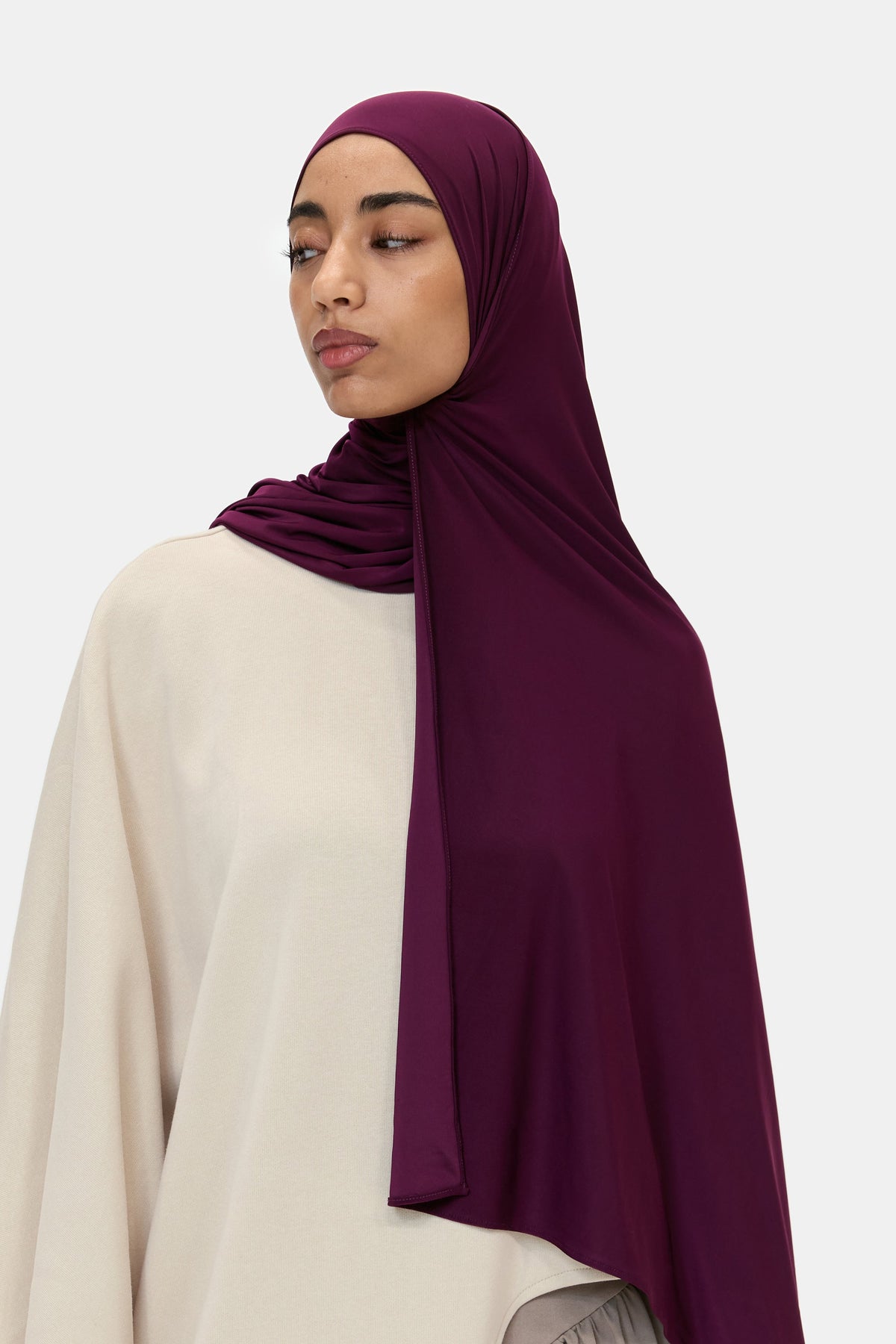 Model wearing the Airy Jersey Scarf in Deep Plum, side view showing the drape