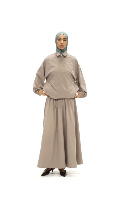 Model walking in the Sculpted Jacket and Sculpted Maxi Skirt in Warm Taupe
