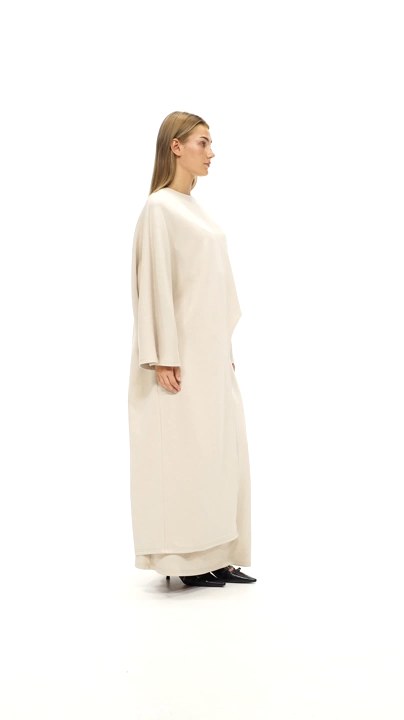 Model walking in The Unique Set in beige, top and matching maxi skirt